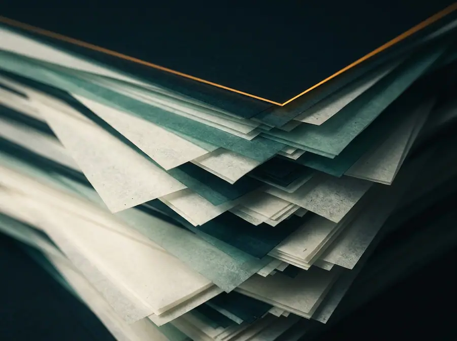 Abstract artwork: layered translucent sheets with edges caught in raking light